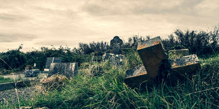 Ireland celtic cross at medieval church cemetery Old spooky cemetery. Haunted cemetery. Scary place. Old gravesの写真素材