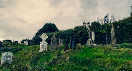 Ireland celtic cross at medieval church cemetery Old spooky cemetery. Haunted cemetery. Scary place. Old gravesの写真素材