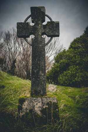 Ireland celtic cross at medieval church cemetery Old spooky cemetery. Haunted cemetery. Scary place. Old gravesの写真素材
