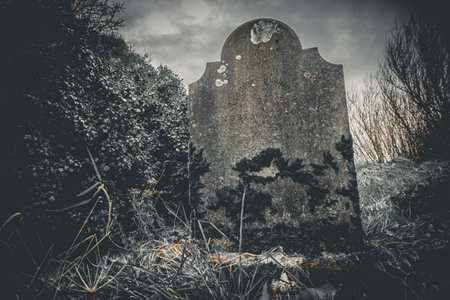 Ireland celtic cross at medieval church cemetery Old spooky cemetery. Haunted cemetery. Scary place. Old gravesの写真素材