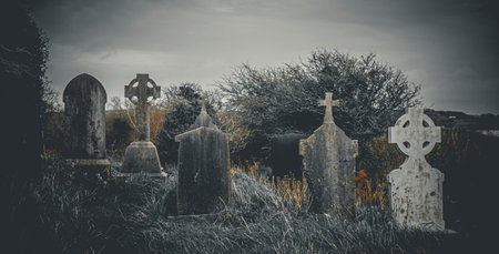 Ireland celtic cross at medieval church cemetery Old spooky cemetery. Haunted cemetery. Scary place. Old gravesの写真素材