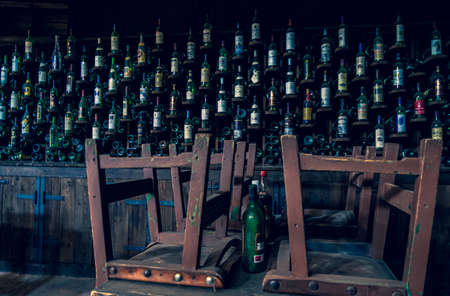 Closed pub for quarantine. old wine bottle background.