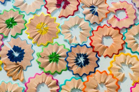 Colorful pencil shavings on blue background. Top view.の写真素材