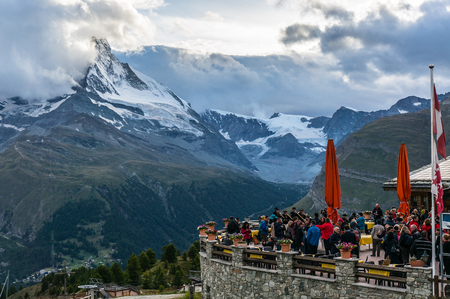 Tourist gathered at restaurant with view of Matterhorn peak.のeditorial素材