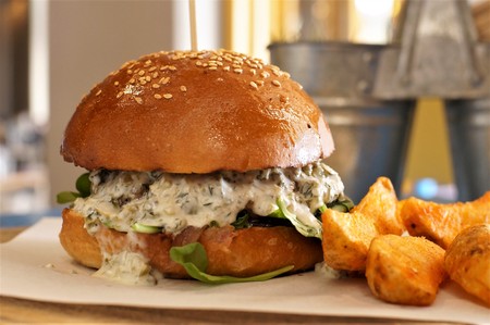 Delicious hamburger with white sauce and fried potatoes.の写真素材
