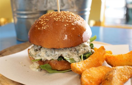 Delicious burger with white sauce and potato friesの写真素材