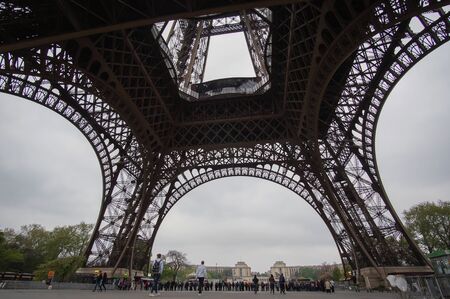 Tourist get in line at the base of Eiffel tower in the morning on April, 11 2017 in Paris, Franceのeditorial素材
