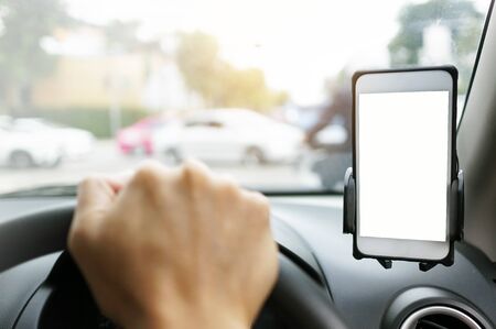 Smart Phone with white screen on car phone Holder while driving with blurry blackground.