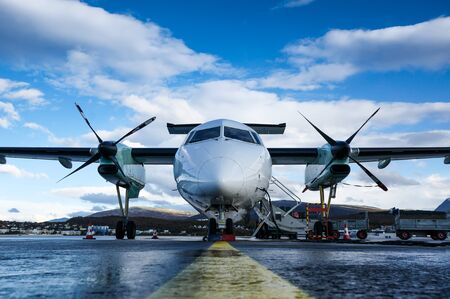 Twin turboprop passenger airplane captured from font uprisen angle parking at Alta airport in Alta, Norwayの写真素材