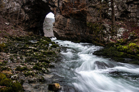 Mountain river flowing through the rocks. Stones in the water in Rakov Skocjan, Sloveniaの写真素材