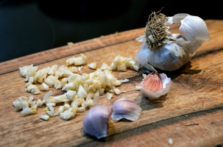 Garlic and onion on a wooden cutting board. Selective focus.の写真素材