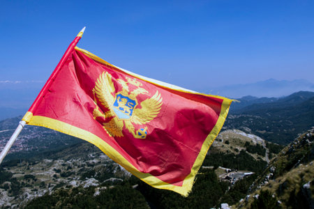 Montenegro flag waving in the wind on top of the mountainsの写真素材
