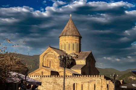 The iconic Svetitskhoveli Cathedral in Mtskheta, Georgia glows in the golden light of sunset.の写真素材