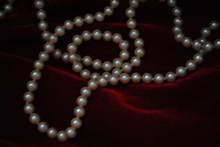 A string of pearls gleams softly through the mysterious dark.  Copy space for text.の写真素材