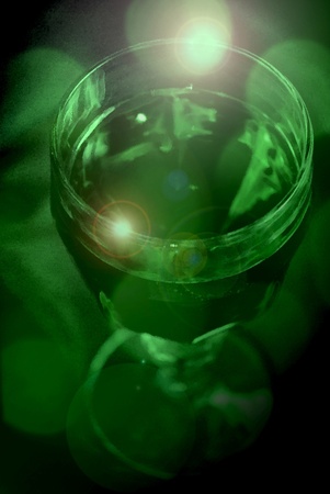 A mysterious glass goblet filled with green liquidの写真素材