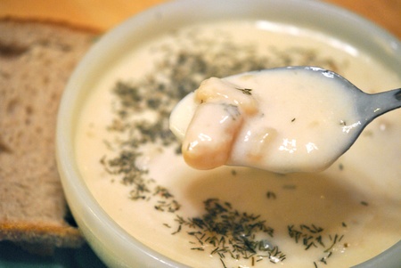 Porringer of potato soup garnished with dill, and a slice of rye bread; a light meatless lunch の写真素材