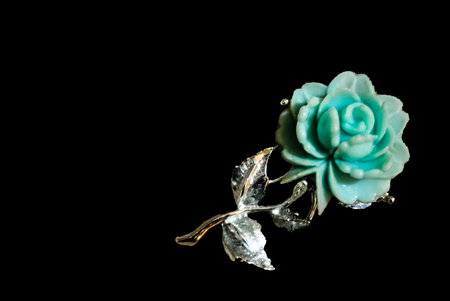 Blue rose brooch isolated on blackの写真素材