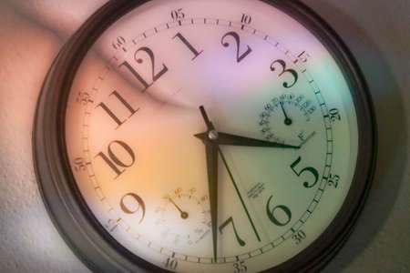 vintage wall clock in light from stained glass windowの写真素材