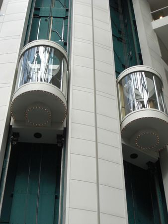 These are glass elevators that used by guests who are staying at a hotel that is inside the airport.