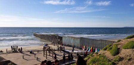 Tijuana, B.C., Mexico, February 24, 2019 - Border wall between Mexico and the U.S.A. at Playas de Tijuana, showing the beach and steel wall dividing both countries.のeditorial素材