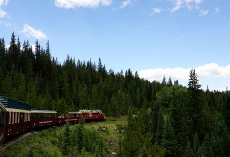 Leadville, Colorado, USA - July 14, 2018 - Leadville Colorado and Southern Railroad tour, with train in movement with blue sky and pine trees.のeditorial素材