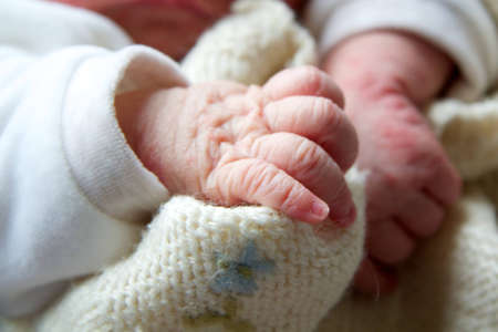the hand of a baby in her cribの写真素材