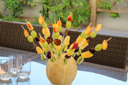 aperitif in the garden with fruit skewersの写真素材