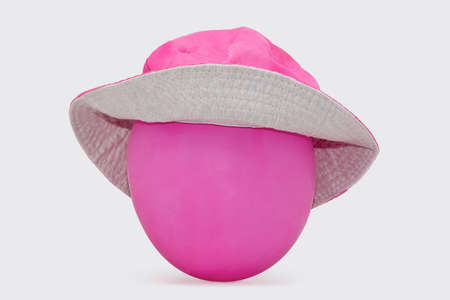 pink balloon hat simulates a face on a white backgroundの写真素材