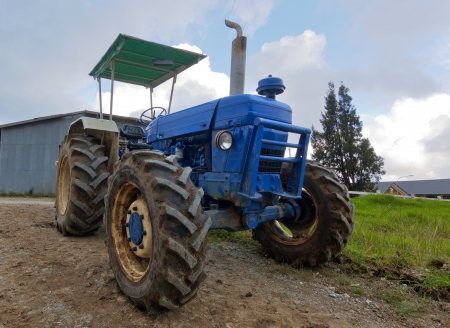 Old tractor at a dairy farmの写真素材