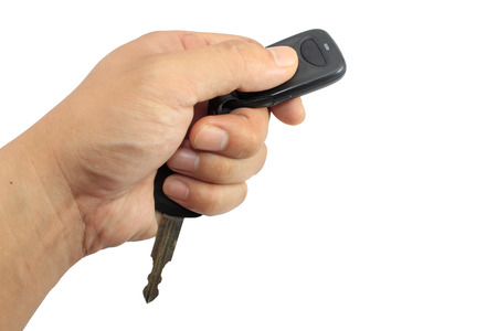 Hand holding car keys isolated on whiteの写真素材