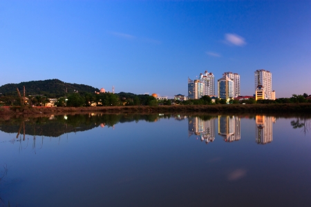 Reflection of buildings and hills at blue hour in Sabah, Borneo, Malaysiaの写真素材