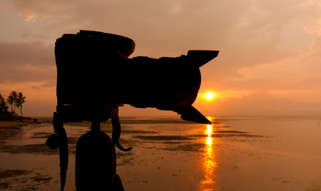Silhouette of a digital camera at sunsetの写真素材