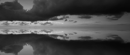 Reflection of dramatic sky in black and whiteの写真素材