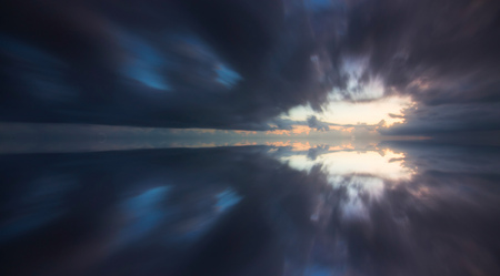 Reflection of dramatic clouds taken with long exposureの写真素材