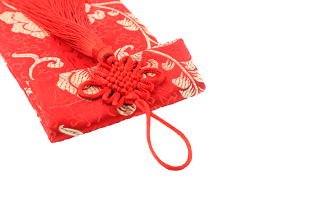 Small red bag with Chinese fabric design isolated on whiteの写真素材
