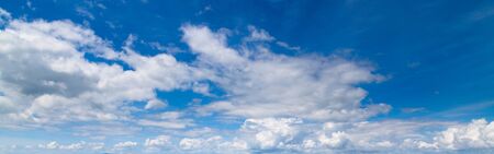 Beautiful blue sky with fluffy clouds for backgroundの写真素材