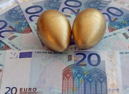 euro bank notes with gold eggsの写真素材