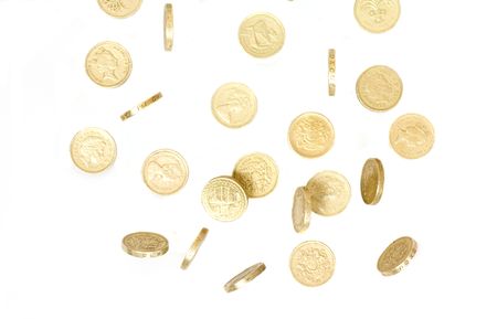 pound coins falling and tumbling on a white back groundの写真素材