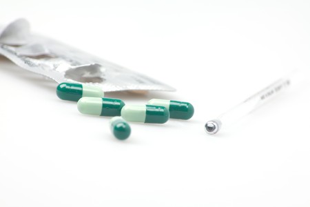 medication capsules  with thermometerの写真素材