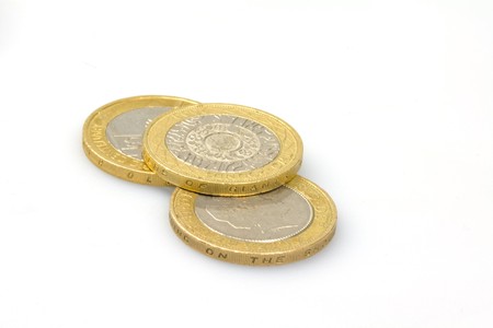british two pound coins on a white backgroundの写真素材
