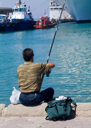 man fishing in the harbour in turkeyの写真素材