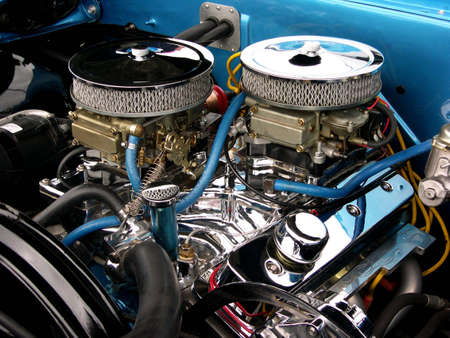 A clean engine compartment consisting of two chrome air filters sitting atop two carburetors.の写真素材
