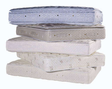 Five mattresses stacked on a white background.の写真素材