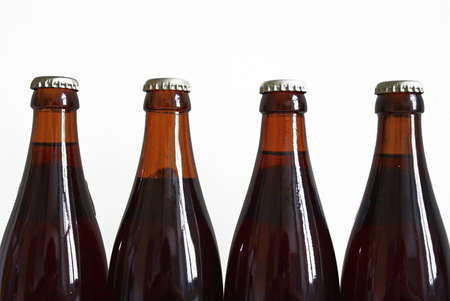 Four bottles of beer on white background.の写真素材
