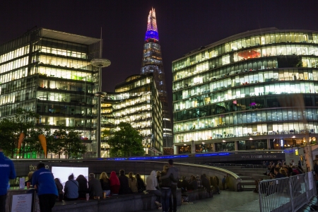London, UK - September 26, 2013  People sitting outside City Hall and watching a movie in central Londonのeditorial素材