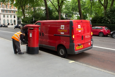 London, UK - June 22, 2013  Royal Mail man collecting the mail from a post box in London のeditorial素材
