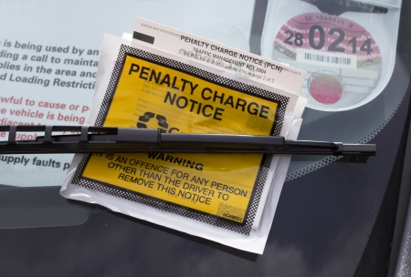 London, UK - May 16th, 2013  A parking penalty notice, under a windscreen wiper on a vehicle  These charges are given when somebody parks their vehicle in a spot where a permit or a pay as you go parking ticket is required のeditorial素材