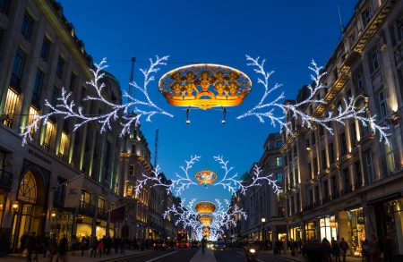 London, UK - November 10, 2013  Regent Street christmas lights lit up against an early evening sky with people walking past on the sidewalks のeditorial素材