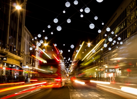 London, UK - November 12, 2013  Oxford Street Christmas lights with the blur of buses going past and shop fronts either sideのeditorial素材