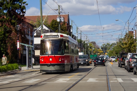 Toronto, Canada - October 8, 2013  A street car in Toronto during the day on a road  This is a popular way to travel around central Toronto by public transportのeditorial素材
